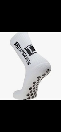 a white sock with black dots on it