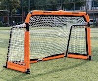 a soccer goal with an orange and black net