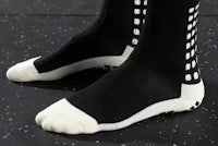a pair of black and white socks with white dots on them