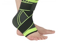 a person's foot with a black and green ankle brace